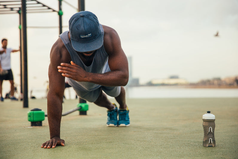 man doing one arm pushup needing electrolytes
